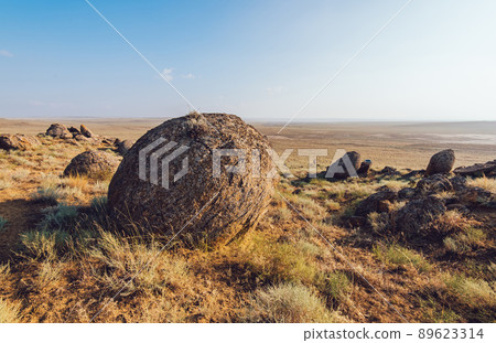 Stones on grassy hill in steppe Stones on grassy hill in steppe 89623314