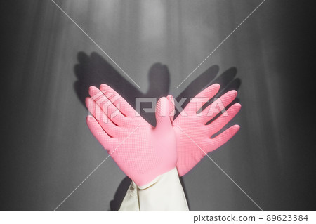 Shadow theater. Hands in rubber gloves shows the figure of a pigeon. On the dark wall, the shadow of the hands in the form of a bird Shadow theater. Hands in rubber gloves shows the figure of a pigeon. On the dark wall, the shadow of the hands in the form of a bird 89623384