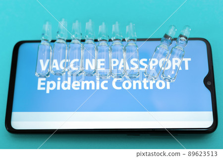 Close up view of smartphone screen with vaccines and electronic Immunity passport. Blue background. Top view. Concept of vaccination from COVID-19 Close up view of smartphone screen with vaccines and electronic Immunity passport. Blue background. Top view. Concept of vaccination from COVID-19 89623513