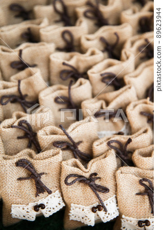 Many small brown bags of fabric Many small brown bags of fabric 89623944