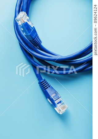 Two Ethernet Cable Connectors Patch cord cord close-up isolated on a blue background with free space Two Ethernet Cable Connectors Patch cord cord close-up isolated on a blue background with free space 89624124