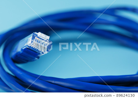 Blue Ethernet Cable Cord Patch cord on a blue background with free space Blue Ethernet Cable Cord Patch cord on a blue background with free space 89624130