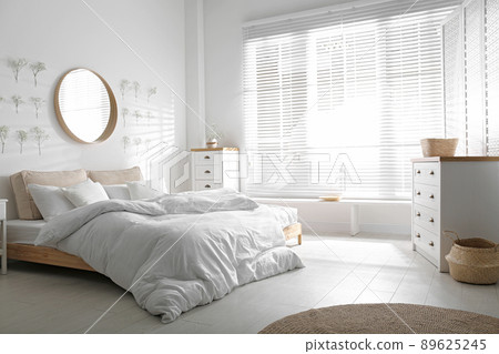 Stylish bedroom interior with white chest of drawers 89625245