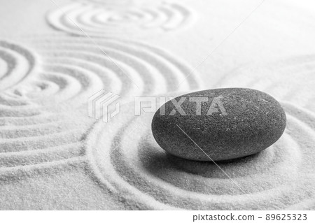 Grey stone on sand with pattern, space for text. Zen, meditation, harmony Grey stone on sand with pattern, space for text. Zen, meditation, harmony 89625323