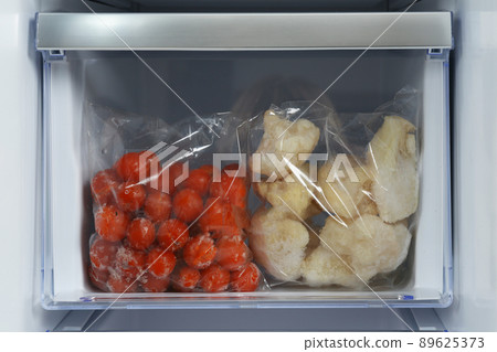 Bags with frozen vegetables in modern refrigerator 89625373