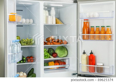 Open refrigerator full of different fresh products 89625374