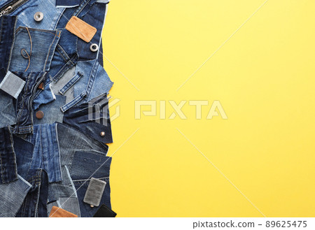 Flat lay composition with patches of old jeans on yellow background. Space for text Flat lay composition with patches of old jeans on yellow background. Space for text 89625475