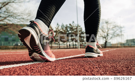 Sport runner girl training. Run woman workout exercise. Runner feet running on road closeup on shoe. Fitness, sport, lifestyle concept. Sport runner girl training. Run woman workout exercise. Runner feet running on road closeup on shoe. Fitness, sport, lifestyle concept. 89626167