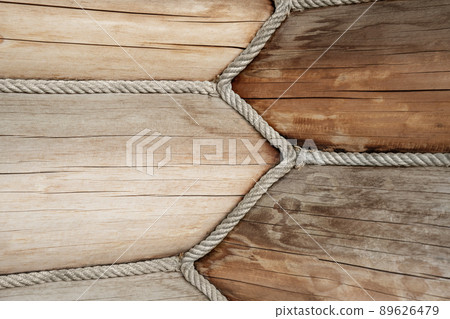 Close-up detail view of wooden log building corner joint decorated with jute rope isolation sealant. Timber beam wall cabin. Eco natural materials house construction concept 89626479