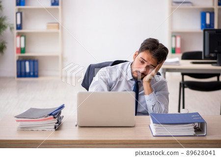 Young male employee working in the office Young male employee working in the office 89628041