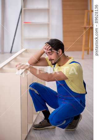 Young male carpenter working at home 89628136