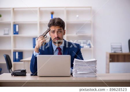 Young businessman employee and too much work in the office 89628523