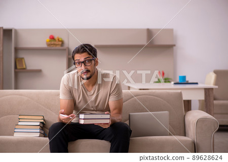 Young male student studying at home during pandemic Young male student studying at home during pandemic 89628624