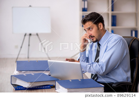 Young male employee working in the office Young male employee working in the office 89629114