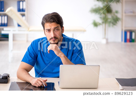 Young male doctor working in the clinic Young male doctor working in the clinic 89629123