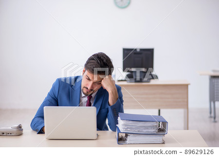Young male employee working in the office Young male employee working in the office 89629126
