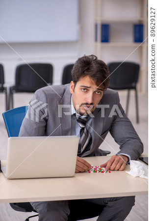 Young businessman employee suffering at workplace Young businessman employee suffering at workplace 89629127