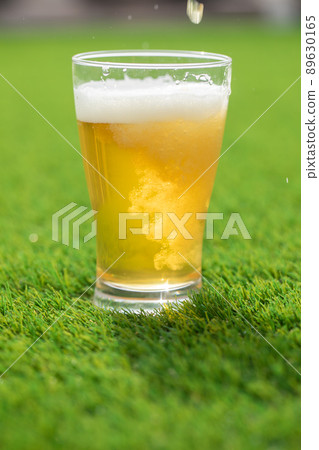 Glass beer on the grass beer 89630165