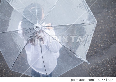 Rain, a woman walking with an umbrella 89631282