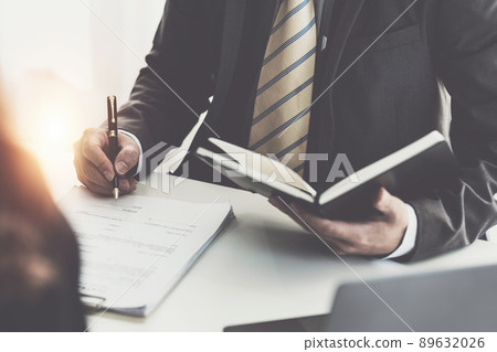 Business woman and lawyers discussing contract papers with brass scale on wooden desk in office. Law, legal services, advice, Justice concept. 89632026