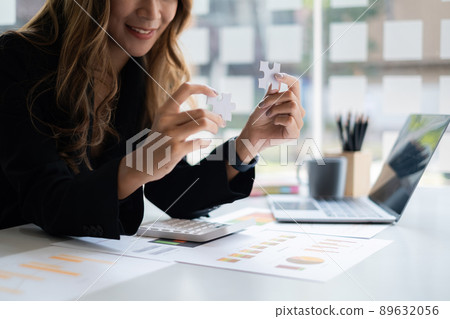 Closeup hand of Business woman connecting jigsaw puzzle. Finance and strategy and success concept. Closeup hand of Business woman connecting jigsaw puzzle. Finance and strategy and success concept. 89632056