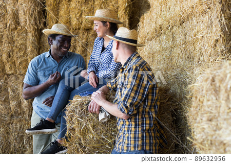 Satisfied farmers after working in hayloft 89632956