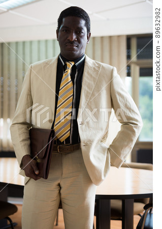 Portrait of a confident african american businessman standing in a office Portrait of a confident african american businessman standing in a office 89632982