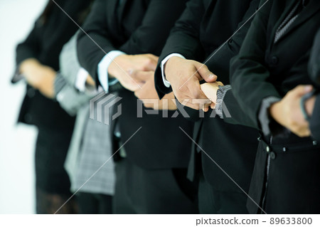 Group of unrecognizable Asian and Caucasian business people holding their hands together, the harmonious and teamwork in businesspeople. Synergy of collaborative businesspeople holding a hands. Group of unrecognizable Asian and Caucasian business people holding their hands together, the harmonious and teamwork in businesspeople. Synergy of collaborative businesspeople holding a hands. 89633800
