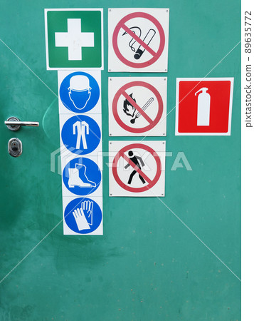Safety signs on a green door for warning Safety signs on a green door for warning 89635772