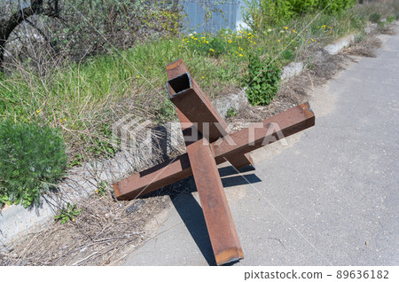 Anti-tank obstacles in the street of a Ukrainian city. Metal barrier hedgehogs. Russian invasion of Ukraine in 2022. No people. Anti-tank obstacles in the street of a Ukrainian city. Metal barrier hedgehogs. Russian invasion of Ukraine in 2022. No people. 89636182