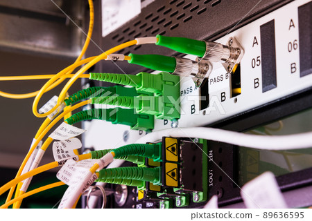 fiber optic cables plugged in network switch panel inside data center fiber optic cables plugged in network switch panel inside data center 89636595