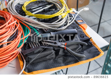 tools of IT administrator with fiber optics network cables 89636615