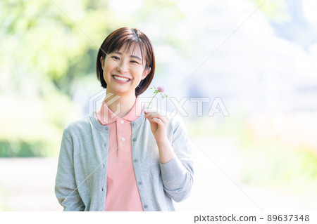 Caregiver female care staff fresh green 89637348