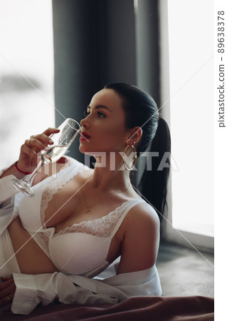 Fashion brunette girl in lingerie lying on bed Fashion brunette girl in lingerie lying on bed 89638378