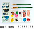 Flat lay sketchbook, watercolor brushes and color palette 89638483