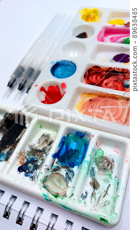 Flat lay sketchbook, watercolor brushes and color palette Flat lay sketchbook, watercolor brushes and color palette 89638485