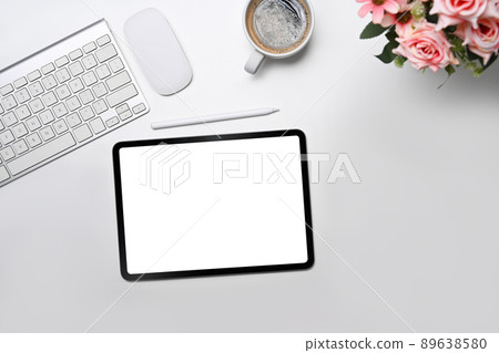 Minimal workplace with digital tablet, coffee cup and flower pot. Flay lay, Top view. Minimal workplace with digital tablet, coffee cup and flower pot. Flay lay, Top view. 89638580