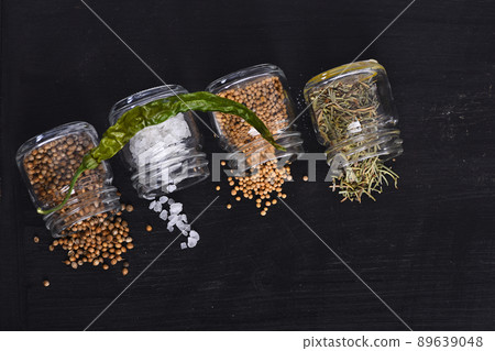 Chili pepper lying on glass bottles with condiment. Chili pepper lying on glass bottles with condiment. 89639048
