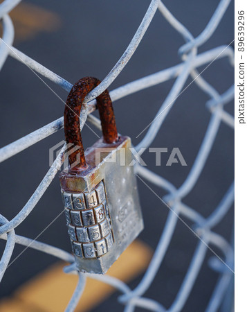 Cylinder lock attached to the fence Cylinder lock attached to the fence 89639296