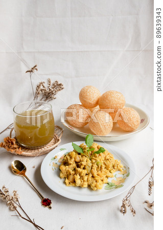 Homemade pani puri, Golgappa Indian snack on cotton calico background Homemade pani puri, Golgappa Indian snack on cotton calico background 89639343