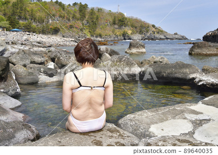 Taking a picture of Mizunashi Kaihin Onsen at Cape Esan, Hakodate, Hokkaido in spring 89640035