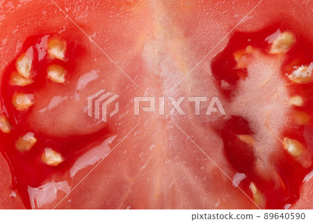 Macro photo of half cut tomato slice with seeds. Tomato slice texture. 89640590