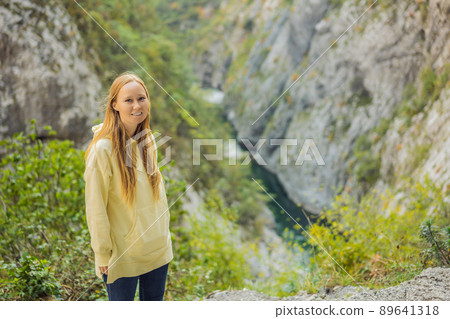 Woman tourist in the background of Beautiful Canyon of Moraca river in winter, Montenegro or Crna Gora, Balkan, Europe Woman tourist in the background of Beautiful Canyon of Moraca river in winter, Montenegro or Crna Gora, Balkan, Europe 89641318