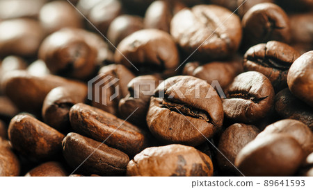 Roasted coffe beans with smoke coming out during cooking. Roasted coffe beans with smoke coming out during cooking. 89641593