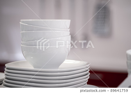Commercial white plates bowls with blurred background at the kitchen Commercial white plates bowls with blurred background at the kitchen 89641759