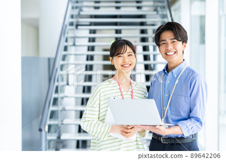 Young male and female engineers in the office 89642206
