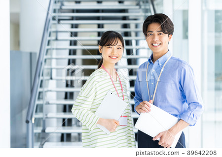 Young male and female engineers in the office 89642208
