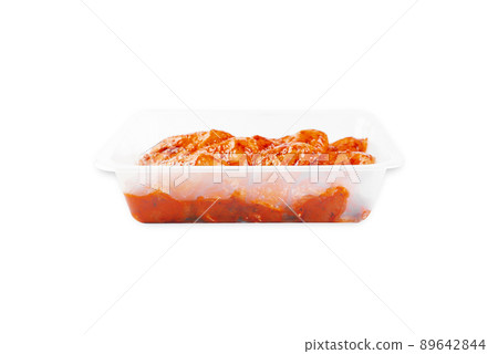 Marinated chicken wings in red sauce on isolated white background.Side view.Copy space.Semifinished. Fast cooking.Raw marinated chicken meat. Marinated chicken wings in red sauce on isolated white background.Side view.Copy space.Semifinished. Fast cooking.Raw marinated chicken meat. 89642844