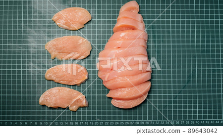 Raw chicken thigh with skin, boneless, for cooking on wooden cutting board.Chicken thigh meat on a linear board. 89643042