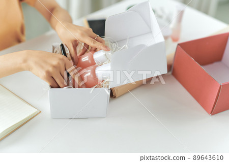 Woman picking beauty box, package and collect the cosmetics product Woman picking beauty box, package and collect the cosmetics product 89643610